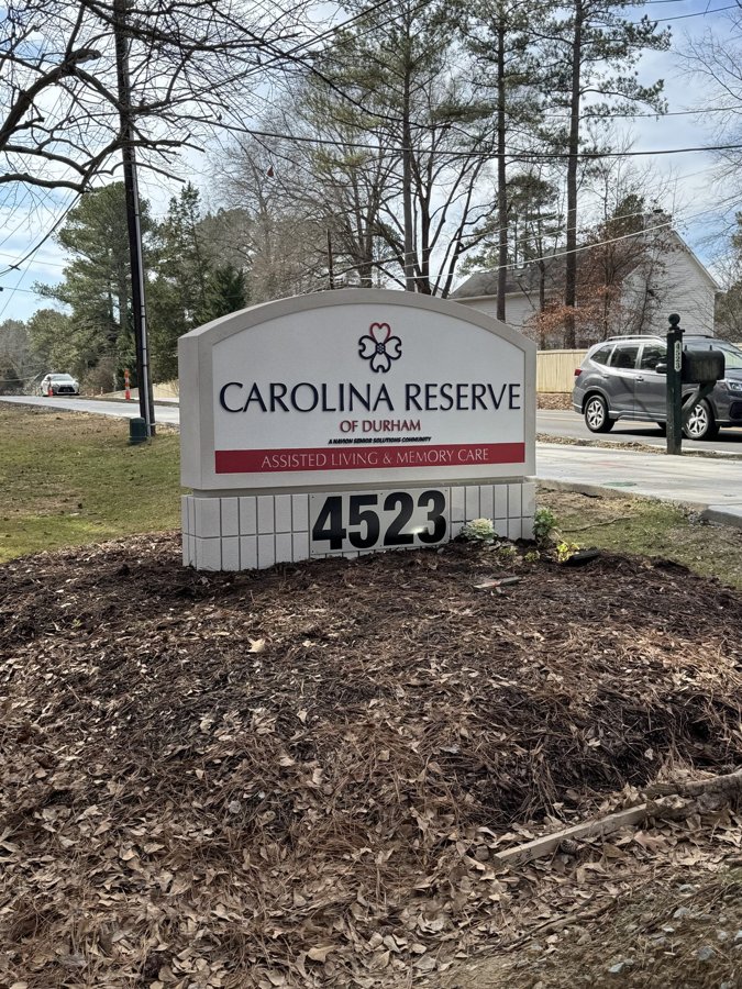 Cream-and-red 'CAROLINA RESERVE 4523' monument sign at a residential community entrance