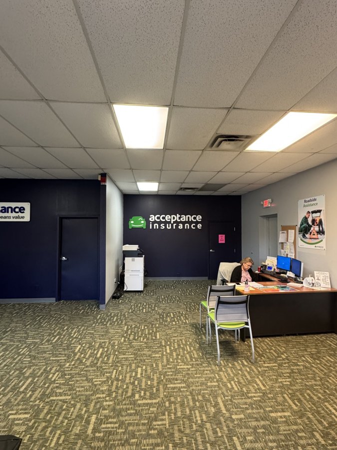 Interior office with dimensional Acceptance Insurance sign visible on far wall