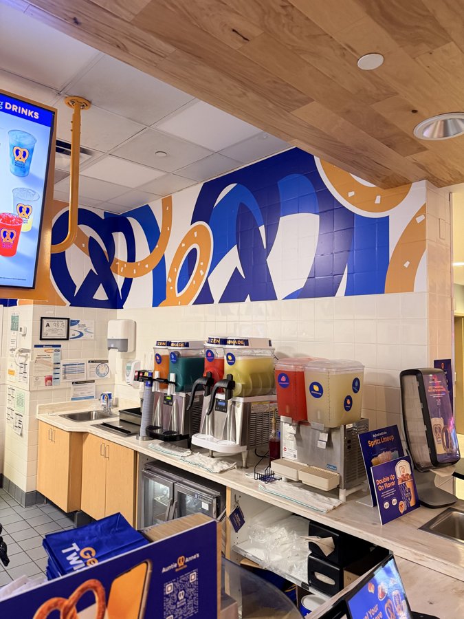 Auntie Anne's counter with wall wrap behind and dispensers