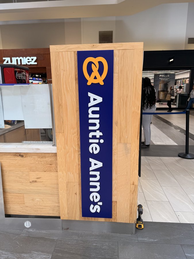 Auntie Anne's kiosk in mall setting near Zumiez storefront