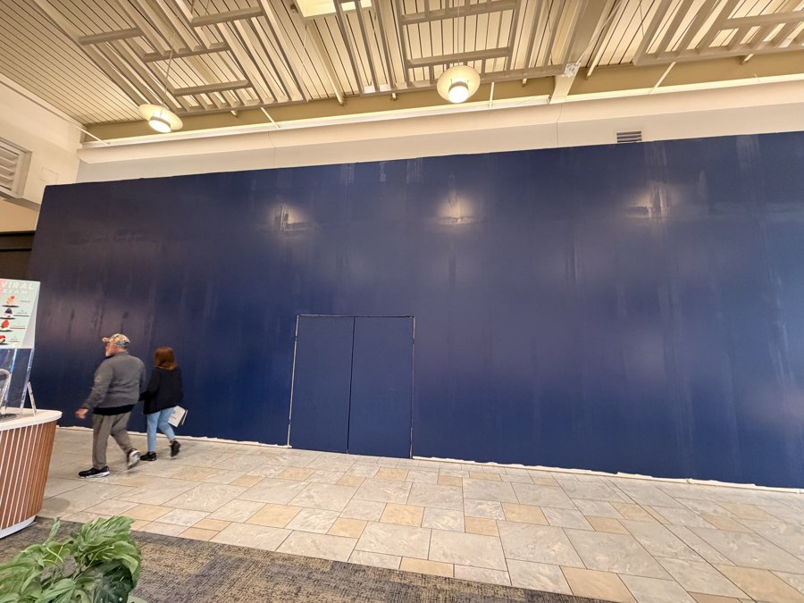 Bath & Body Works hoarding at storefront entrance with mall shoppers
