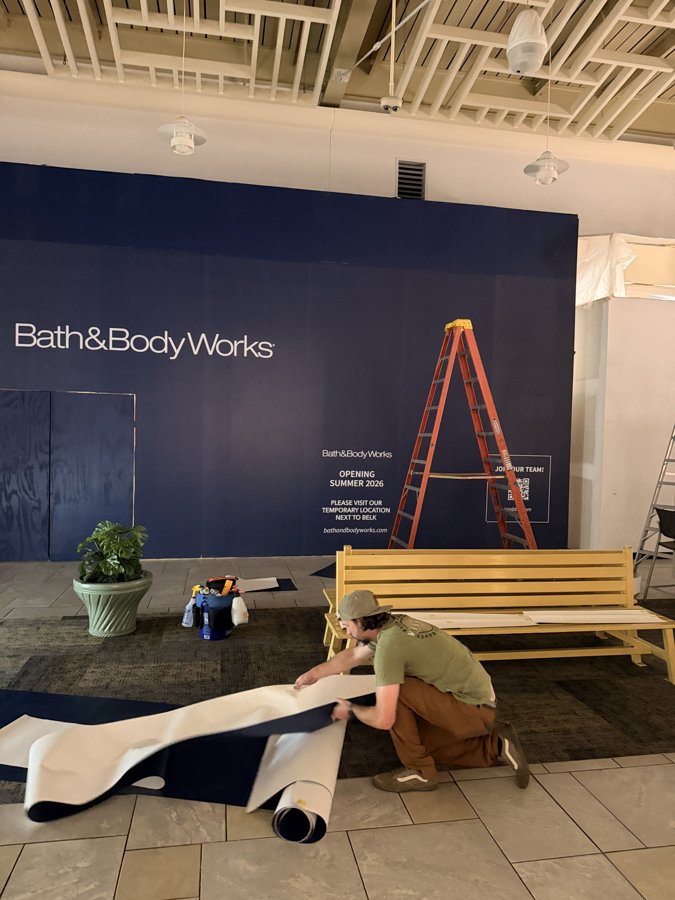 Bath & Body Works hoarding with brand signage and ladder