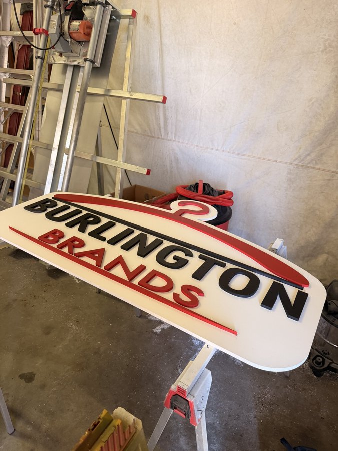 Detail view of Burlington Brands oval sign showing edge construction
