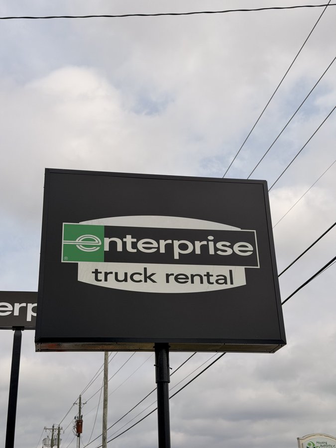Close-up of Enterprise Truck Rental pylon sign showing panel construction