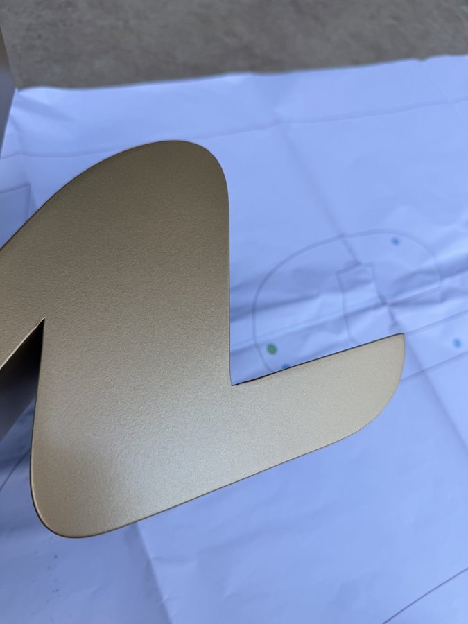 Close detail of gold letter Y showing clean fabricated edge