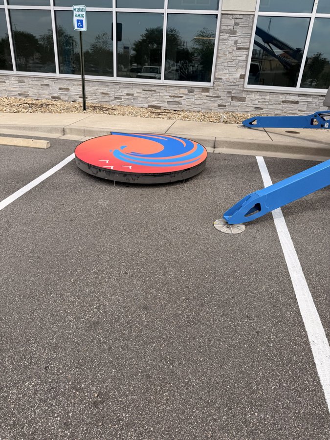 Large illuminated channel letter laid out on parking lot before install