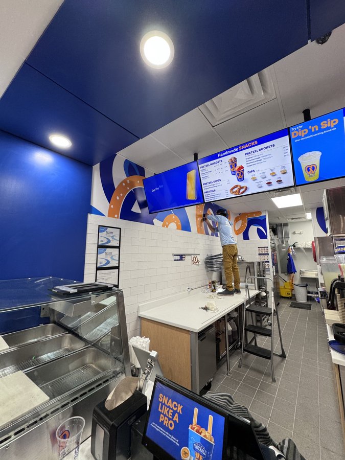 Interior showing overhead digital menu board install