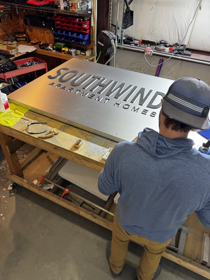 Craftsman assembling SOUTHWINDS POINT dimensional letters in the shop