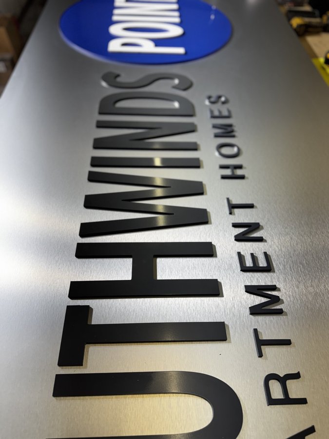 Close-up of POINT letters with blue oval logo detail