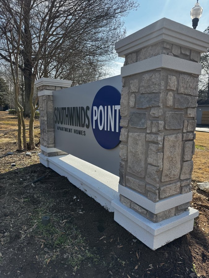 Wide view of Southwinds Point stone monument in landscape