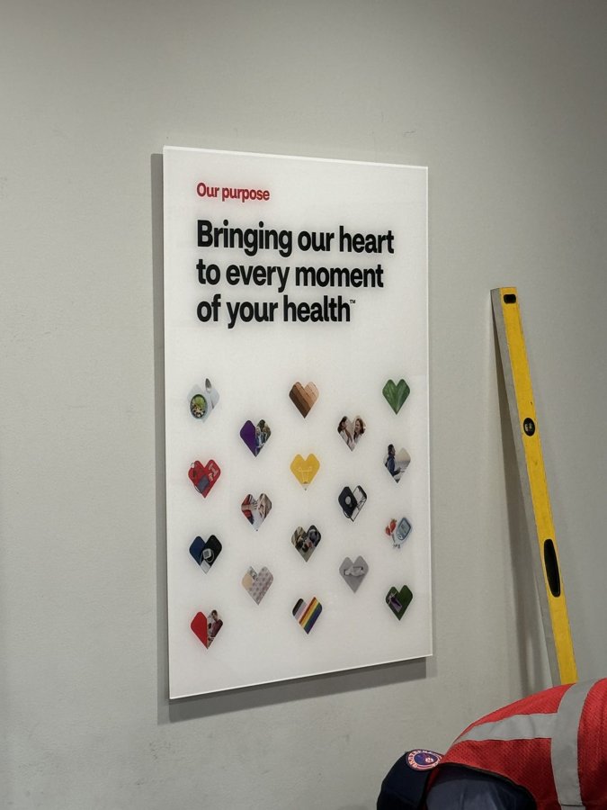 Large 'Bringing our heart to every moment of your health' framed wall graphic with colorful heart illustrations