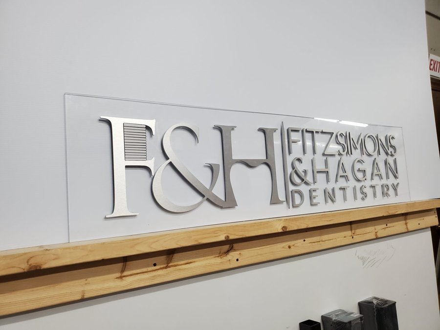 Brushed-aluminum 'F&H FITZSIMONS & HAGAN DENTISTRY' dimensional letters ready for install
