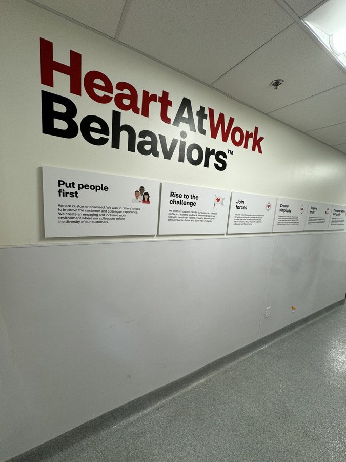 'HeartAtWork Behaviors' dimensional headline with sub-panels installed on an interior corporate wall